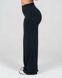 Person wearing black wide-leg pants on a white background