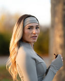 Woman in athletic wear with a headband outdoors