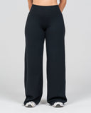 Black wide-leg pants worn by a person on a light gray background