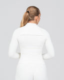 Person wearing a white outfit on a plain background