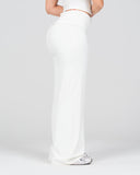 Person wearing a white outfit on a plain background