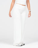 Person wearing a white outfit on a plain background